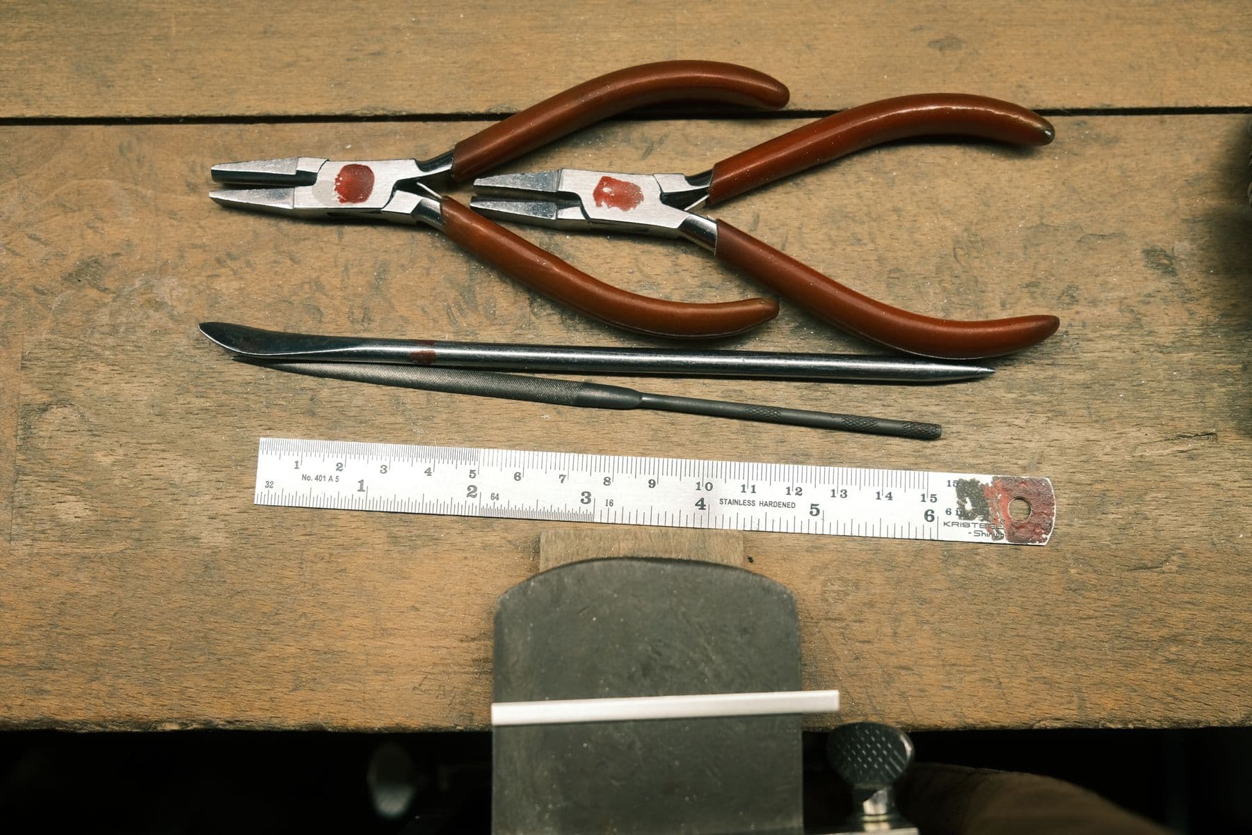 Hand tools laid out in order on a workbench