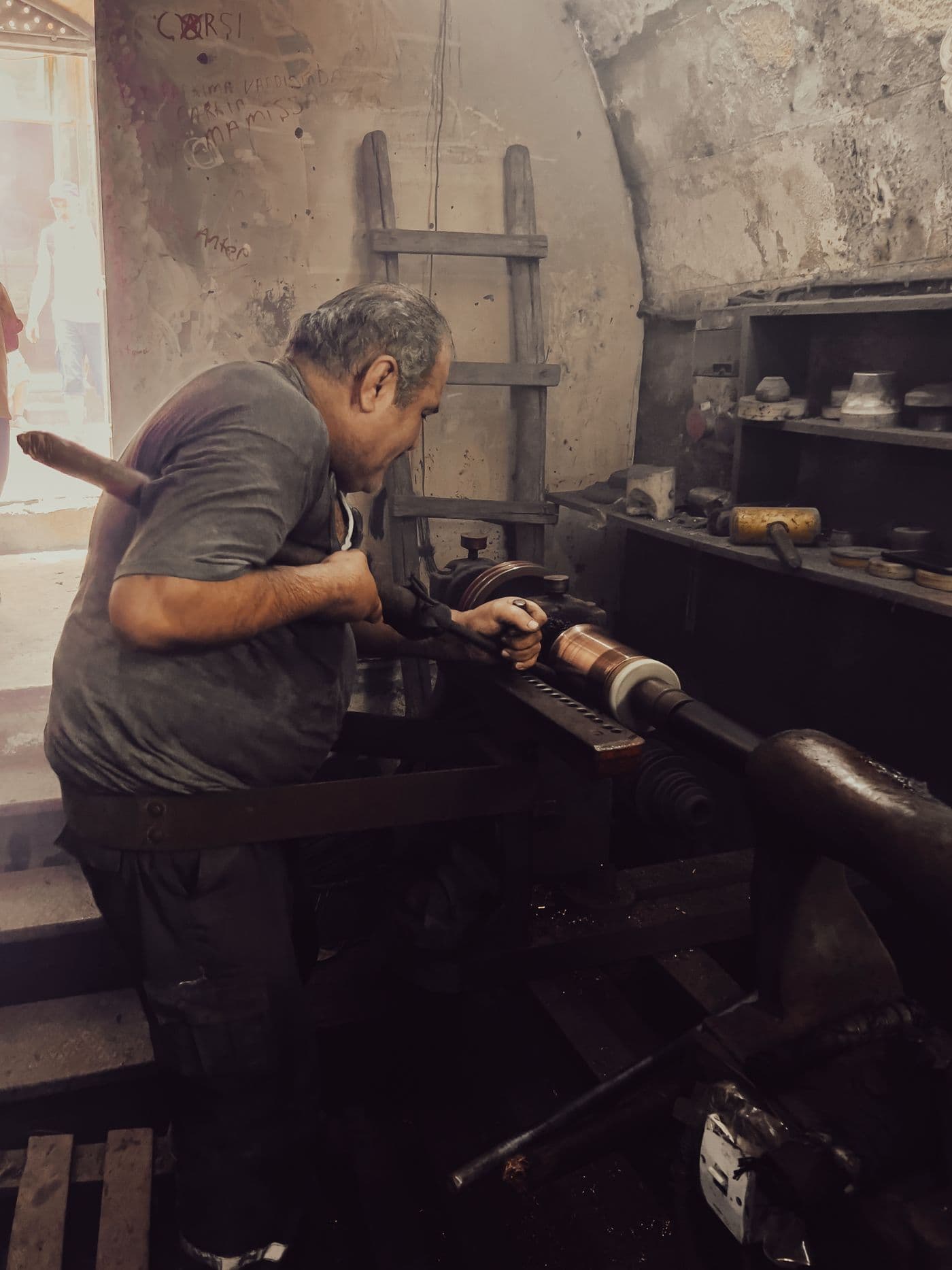 Hands guiding work on a lathe, close and deliberate